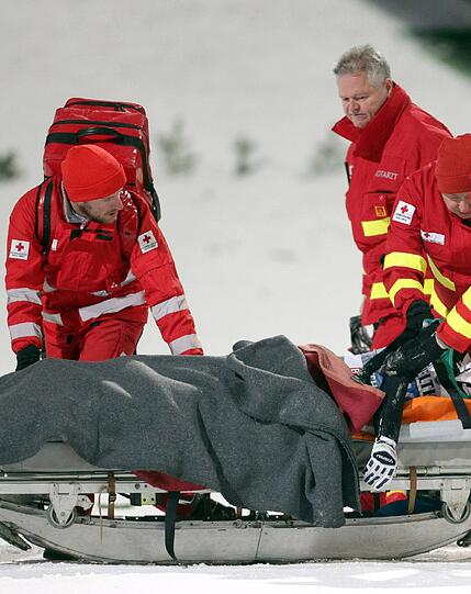 Mit einer Trage wird der bewusstlose Ammann in eine Klinik Transportiert.
