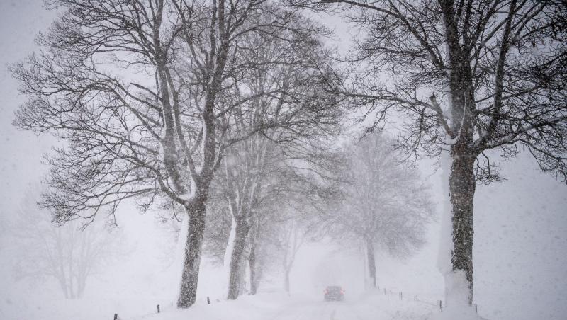 Ein Auto fährt über eine Schnee verwehte Landstraße. Foto: Lino Mirgeler/Archiv Ein Auto fährt über eine Schnee verwehte Landstraße. Foto: Lino Mirgeler/Archiv