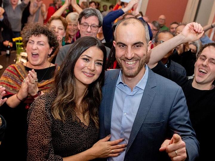 Belit Onay (Bündnis 90/Die Grünen), Spitzenkandidat bei der Oberbürgermeisterwahl, freut sich mit seiner Frau Derya (l) und seinen Unterstützern nach Bekanntgabe der Wahlergebnisse.