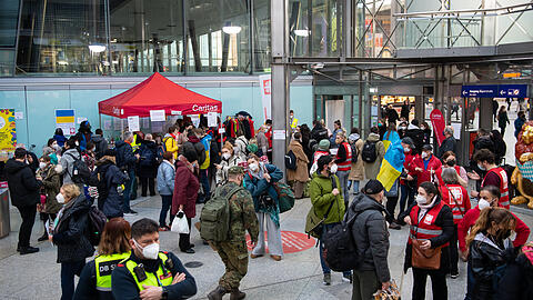 Flüchtlinge aus der Ukraine werden nach ihrer Ankunft am Hauptbahnhof von Mitarbeitern der Caritas und freiwilligen Helfern empfangen.