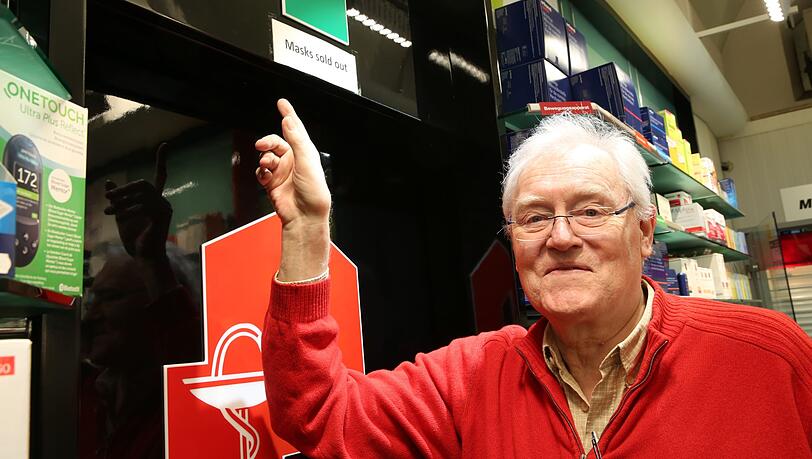 Josef Grimm, Chef der Rathausapotheke, zeigt auf das Schild "Sold out".