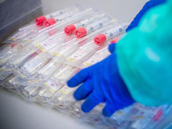 Testsets mit Abstrichstäbchen liegen in einem Testzentrum für Corona-Verdachtsfälle bereit.