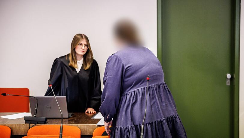 Die Angeklagte Andrea Tandler (r) steht zu Prozessbeginn an ihrem Platz im Gerichtssaal.