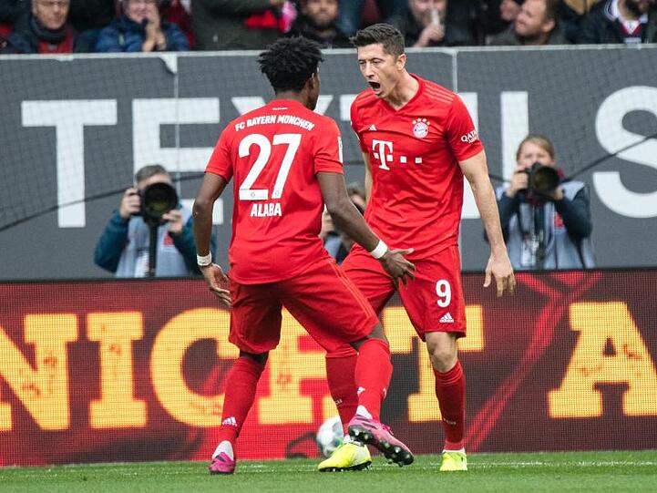 David Alaba (l.) und Torschütze Robert Lewandowski vom FC Bayern München jubeln über den Treffer zum 1:1. Foto: Matthias Balk/dpa