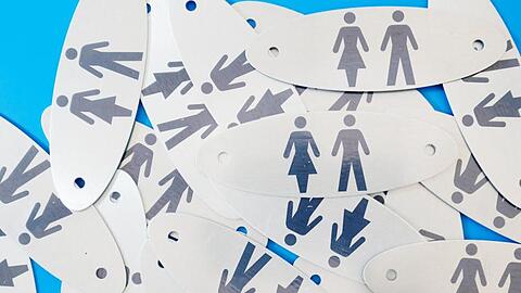 Plaketten für Toiletten liegen auf dem Boden. Foto: Sebastian Willnow/Archiv