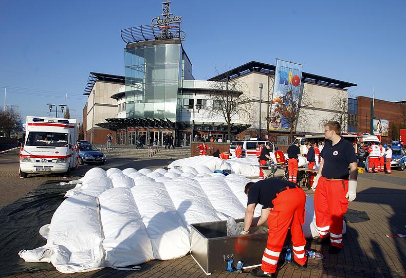 Rettungskraefte packen am Sonntag in Oberhausen vor dem Einkaufszentrum ihre Ausrüstung zusammen.