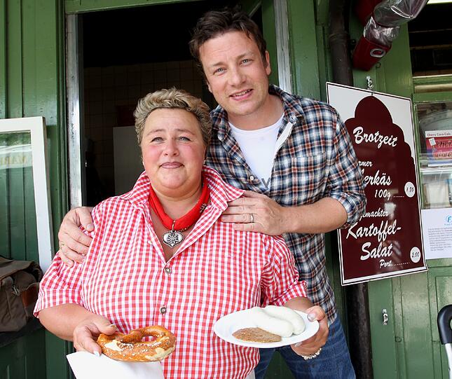 &bdquo;Do you want a Weißwurst?&ldquo; Der britische Koch-Star Jamie Oliver verkauft mit Manuela Teltschik an ihrem Standl Würste.