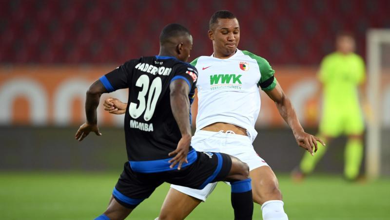 Streli Mamba von Paderborn und Felix Uduokhai von Augsburg (l-r.) in Aktion. Foto: Matthias Hangst/Getty Images Europe/Pool/dpa