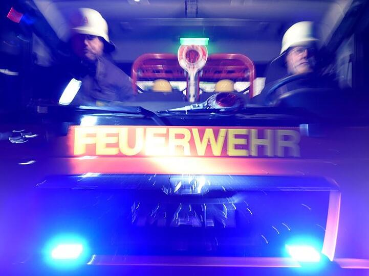 Feuerwehrmänner in einem Löschfahrzeug. Foto: Carsten Rehder/dpa/Symbolbild