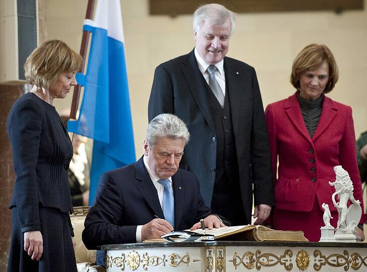 Im Kuppelsaal der Staatskanzlei hat sich der Bundespräsident (2.v.l.) ins Gästebuch der Staatsregierung eingetragen.