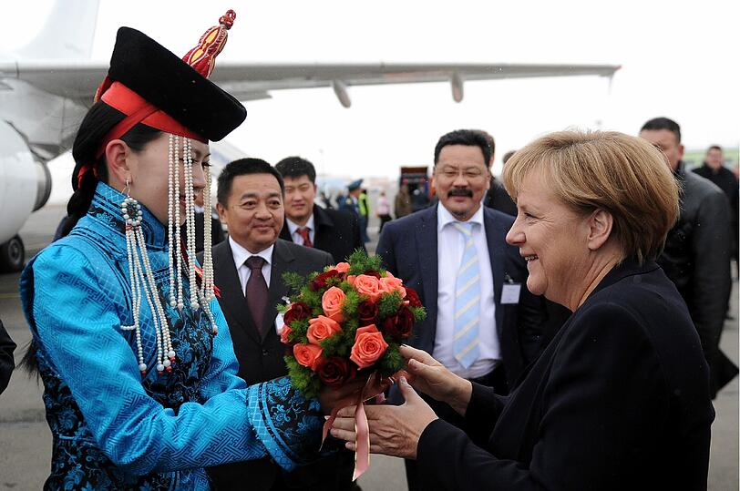Zum Abschied gibt's noch ein paar Blumen für die Kanzlerin...