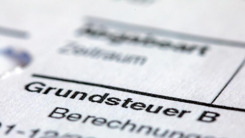 Ein Abgabenbescheid für die Entrichtung der Grundsteuer liegt auf einem Schreibtisch. Foto: Jens Büttner/zb/dpa/Archivbild Ein Abgabenbescheid für die Entrichtung der Grundsteuer liegt auf einem Schreibtisch. Foto: Jens Büttner/zb/dpa/Archivbild