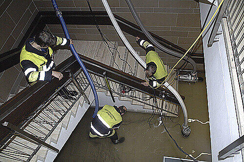 Mit Spezialpumpen saugen Feuerwehrleute die abgesoffenen Kellerräume im Dantebad ab