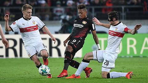 Der Leverkusener Leon Bailey (Mitte) behauptet sich gegen die Stuttgarter Santiago Ascacibar und Christian Gentner (rechts).