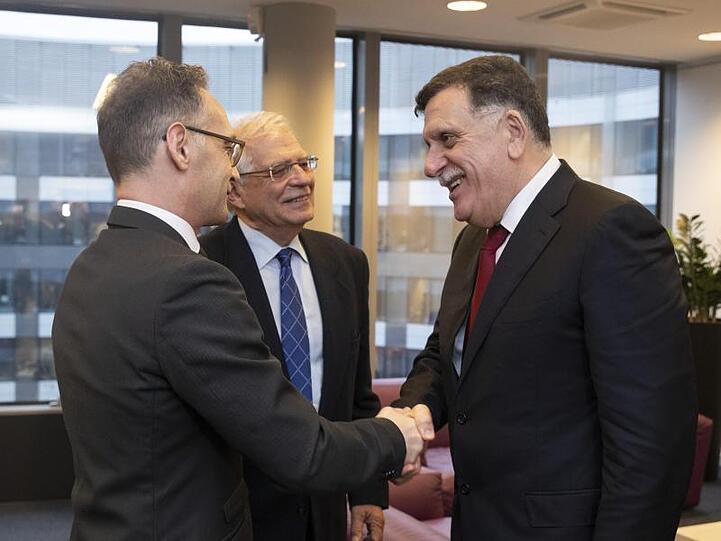 Außenminister Heiko Maas und Libyens international anerkannter Regierungschef Fajis al-Sarradsch begrüßen sich in Brüssel.