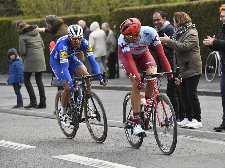 Philippe Gilbert (l) und Nils Politt belauern sich auf der Strecke.