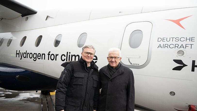 Josef Kallo (l), CEO der H2Fly, mit Baden-Württembergs Ministerpräsident Winfried Kretschmann auf dem Flughafen Stuttgart.