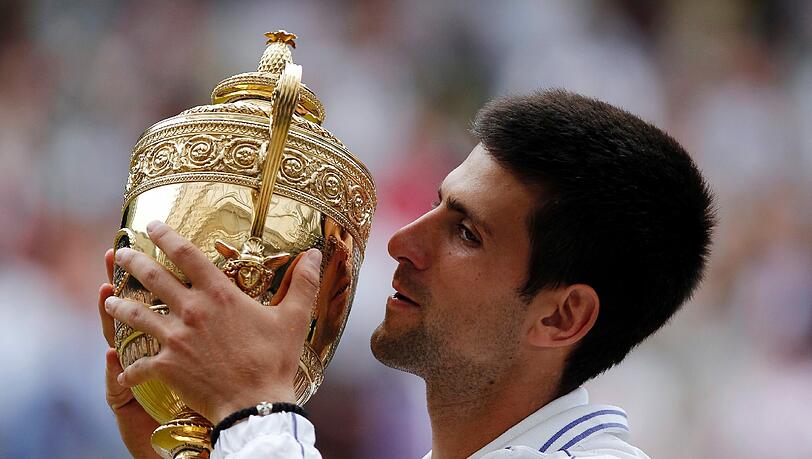 Novak Djokovic küsst den Sieger-Pokal in Wimbledon. Novak Djokovic küsst den Sieger-Pokal in Wimbledon.