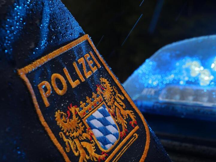 Ein Polizist steht vor einem Streifenwagen, dessen Blaulicht aktiviert ist. Foto: Karl-Josef Hildenbrand/dpa/Symbolbild