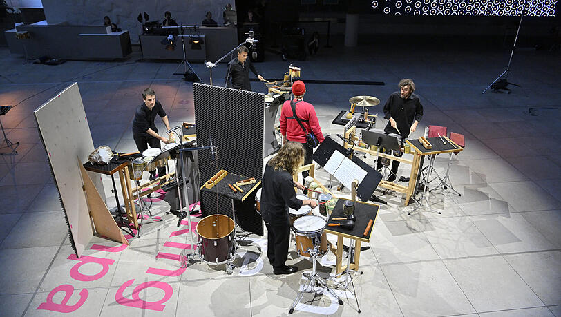 Konzert mit rotem Avatar: Die Schlagzeuger der Philharmoniker in einem Veranstaltungsraum neben dem ehemaligen Tower des Flughafens Riem.