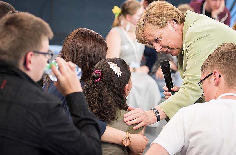 Bundeskanzlerin Angela Merkel im Sommer beim Bürgerdialog im Gespräch mit Flüchtlingskind Reem.