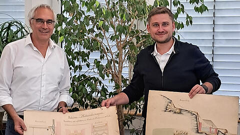 Dr. Alexander Wiesneth von der Schlösserverwaltung (links) mit Roman Stadelmaier bei der Übergabe des Plankonvoluts.
