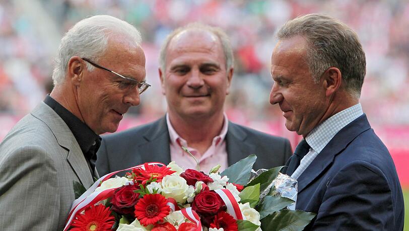 Der Ehrenpräsident des FC Bayern, Franz Beckenbauer (l), erhält vom FC Bayern Vorstandsvorsitzenden Karl-Heinz Rummenigge einen Blumenstrauß.