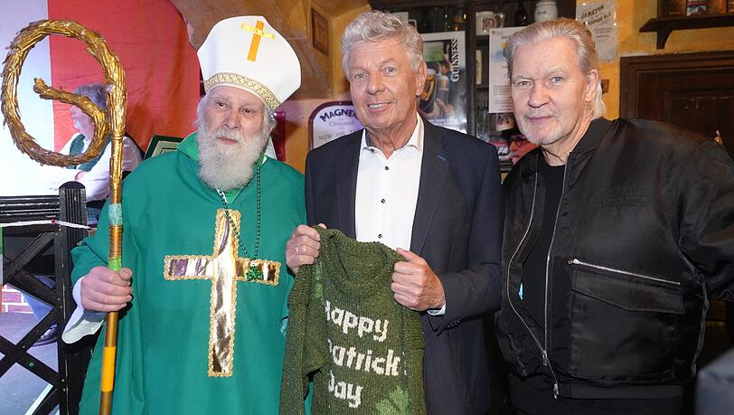 V.l.: Wolfgang Schramm alias St. Patrick, OB Dieter Reiter (SPD) und der dreifache ESC-Gewinner und M&uuml;nchen-Freund Johnny Logan auf der Pressekonferenz zum diesj&auml;hrigen St. Patrick&rsquo;s Day. Zum 30. Jubil&auml;um haben die Organisatoren Dieter Reiter einen gr&uuml;nen Pullover geschenkt.