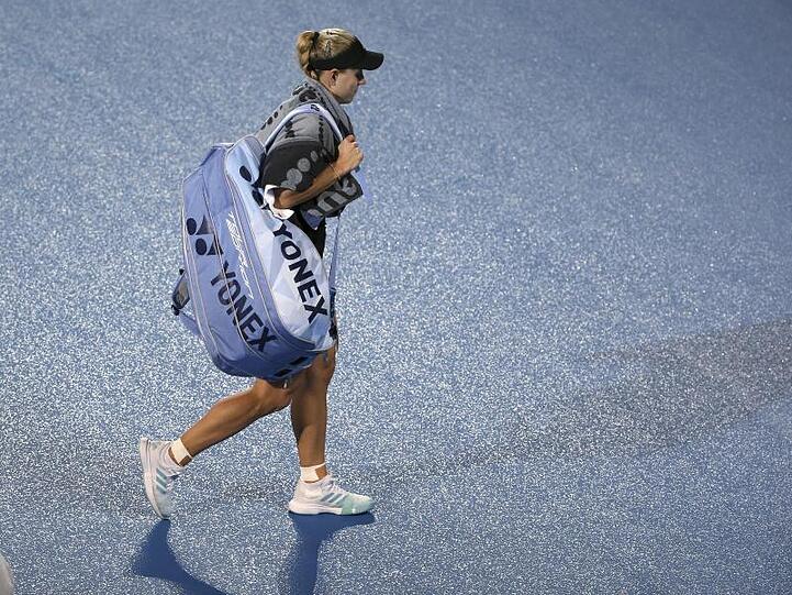 Angelique Kerber geht nach ihrer Niederlage durch Petra Kvitova vom regennassen Platz.