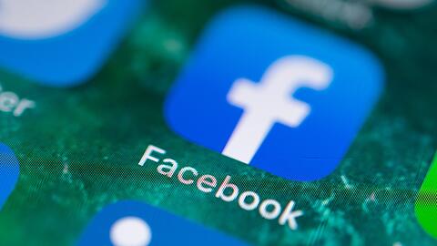 Auf dem Bildschirm eines iPhones wird die App Facebook angezeigt.