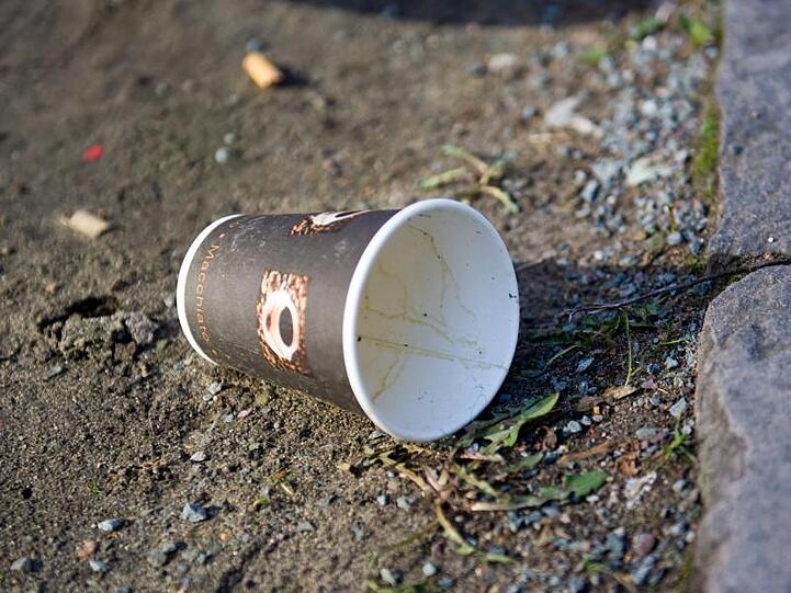 Ein schneller Kaffee für unterwegs - und dann den Becher wegwerfen: Gerade Kaffeebecher nehmen in Städten in öffentlichen Mülleimern viel Platz weg - und manchmal auch gleich auf dem Bordstein.