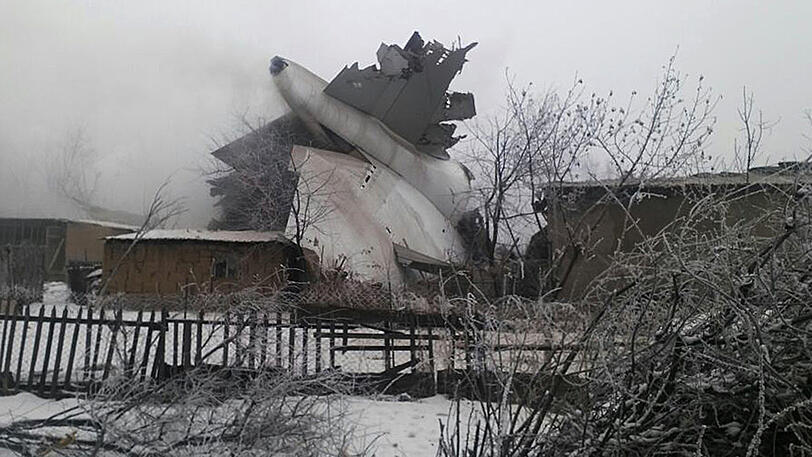 Ein Wrack eines Frachtflugzeugs der Fluggesellschaft ACT liegt am am Montag nahe des Flughafens Manas in Bischkek (Kirgistan) in bewohntem Gebiet.