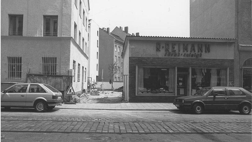 1990 steht am Straßenrand noch das Gebäude der Reinigung. Hinten ist Brachland. 1990 steht am Straßenrand noch das Gebäude der Reinigung. Hinten ist Brachland.