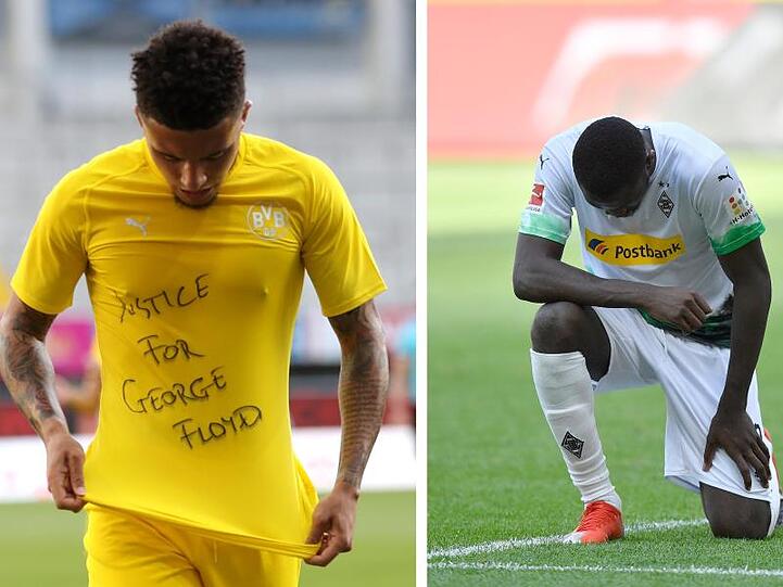 Jadon Sancho (l) trägt ein Trikot mit dem Schriftzug "Justice for George Floyd". Gladbachs Marcus Thuram kniet auf dem Rasen.