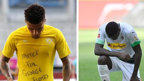 Jadon Sancho (l) trägt ein Trikot mit dem Schriftzug "Justice for George Floyd". Gladbachs Marcus Thuram kniet auf dem Rasen.