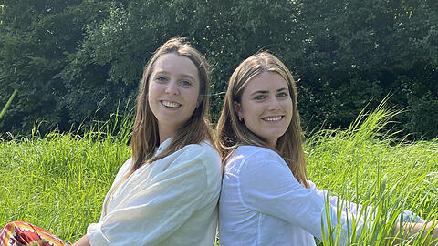 Ihr Gras darf lange wachsen, wie dieses hier im Bild. Denn die Münchnerin Katharina (Kati) Lehmkuhl (r.) und Melusine Bliesener lassen daraus kompostierbares Bio-Geschenkpapier machen.