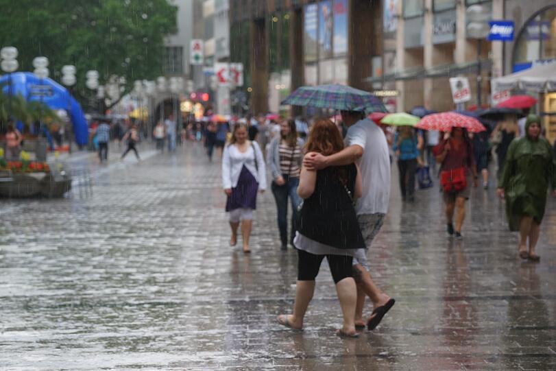 Kurzer Regenschauer bei Shoppen und schauen beim verkaufsoffenen Sonntag in der Fußgängerzone.