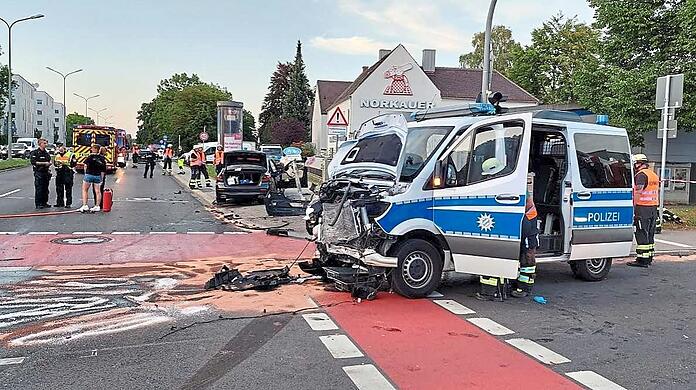 Das schwer beschädigte Polizeifahrzeug, im Hintergrund steht der schwarze BMW.