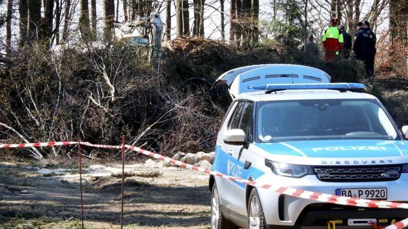 Polizeibeamte durchsuchen eine Fläche an einem Waldrand bei Flossenbürg. Foto: