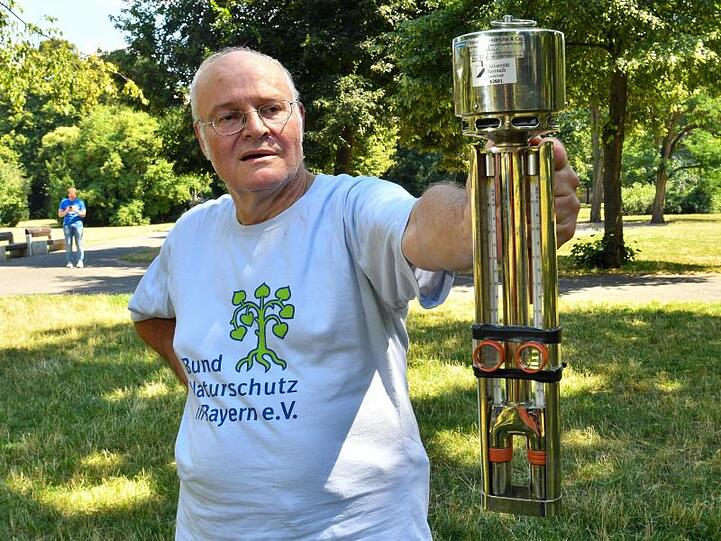 Richard Styr vom Bund-Naturschutz misst die Temperatur über einer Wiese. Foto: Berny Meyer