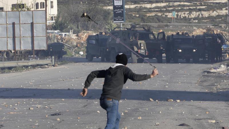 Ein Palästinenser wirft Steine auf israelische Sicherheitskräfte. Die israelische Armee hat die Stadt Ramallah, das Verwaltungszentrum der Palästinenser im Westjordanland, abgeriegelt. Ein Palästinenser wirft Steine auf israelische Sicherheitskräfte. Die israelische Armee hat die Stadt Ramallah, das Verwaltungszentrum der Palästinenser im Westjordanland, abgeriegelt.