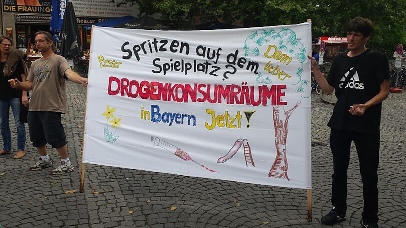Zwei Demonstranten mit ihrem Banner bei der Mahnwache am Sendlinger Tor.	Foto: Linda Jessen