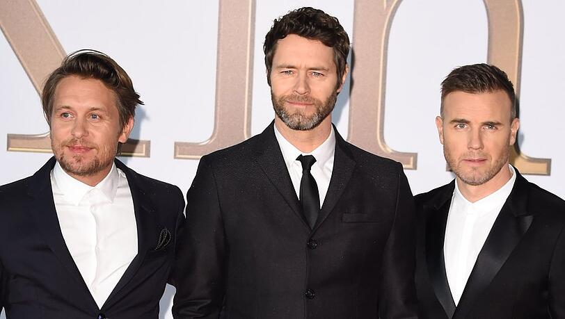 Mark Owen, Howard Donald und Gary Barlow (v.l.) sollen bei einem Musikkonzert auf Schloss Windsor auftreten.