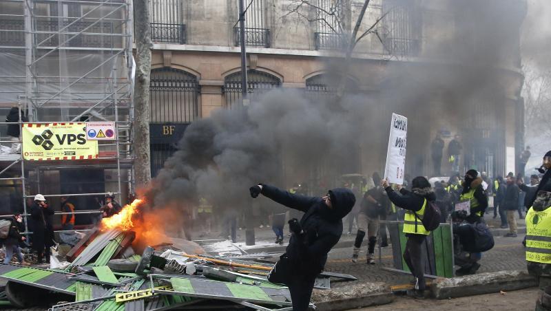 Ein Demonstrant in Paris bewirft die Polizei. Ein Demonstrant in Paris bewirft die Polizei.