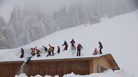 Einsatzkräfte schaufeln das verschüttete Hotel Hubertus in Balderschwang frei.