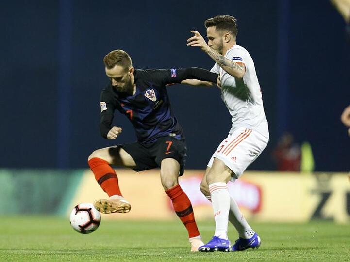 Ivan Rakitic aus Kroatien (l) im Kampf um den Ball mit dem Spanier Saul Niguez.