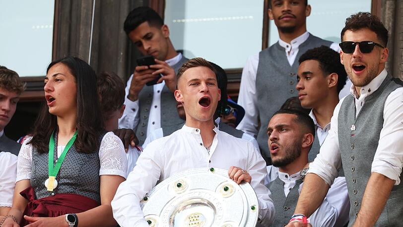 Bayerns Joshua Kimmich (M) jubelt mit der Meisterschale auf dem Rathaus-Balkon.