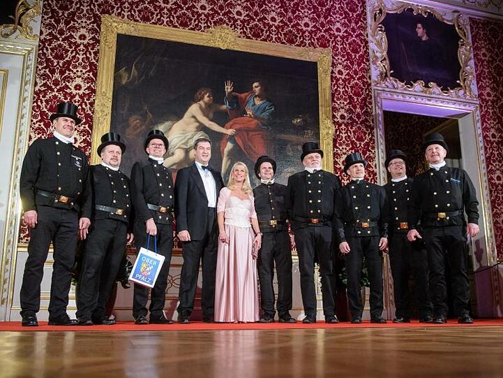 Markus Söder und seine Frau Karin Baumüller-Söder empfangen eine Gruppe von Schornsteinfegern auf dem Neujahrsempfang. Foto: Matthias Balk