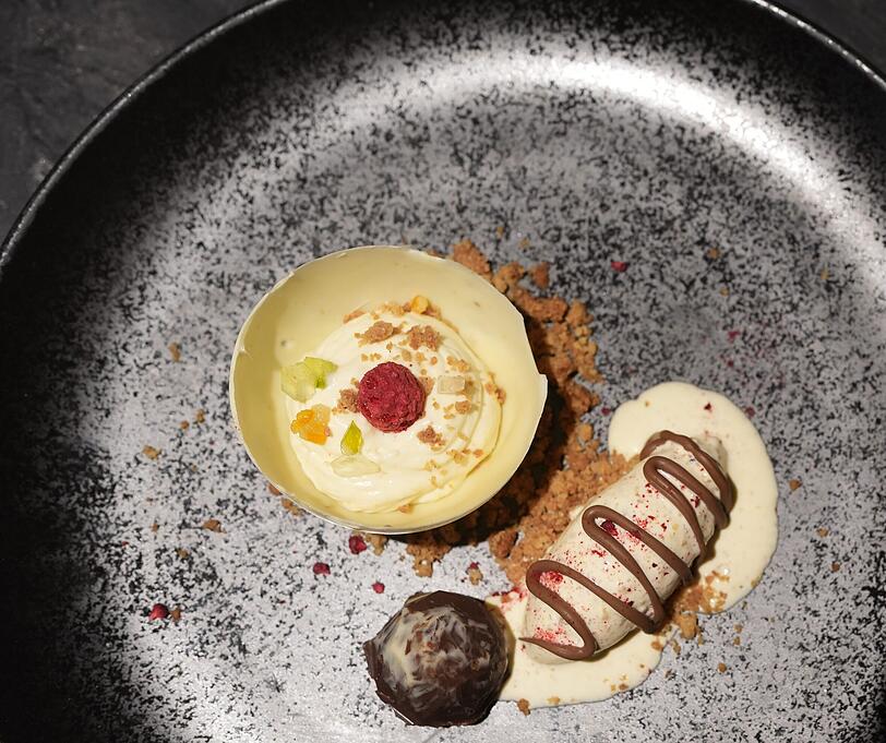 Fünfter Gang: Weiße Schokoladenkugel mit kandierten Früchten, Ingwercrumble, Panettone-Eis.