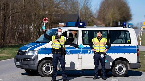 Polizisten stehen in der Nähe von Neuhaus am Inn an einer Kontrollstelle an der Grenze zu Österreich.